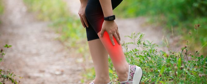 Pain in woman's shin, massage of female leg, injury while running, trauma during workout, outdoors concept