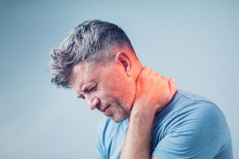 A man suffering from neck pain.